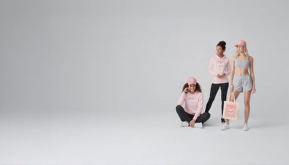 Three women wearing pink and gray athletic wear with a tote bag on a light gray background